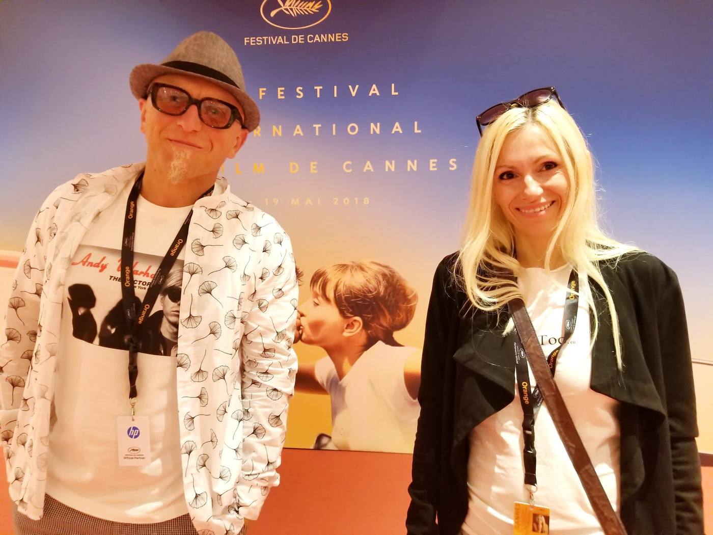 Petro Dushkov and Maria Bobeva smiling with festival badges in front of the 71st Festival de Cannes backdrop
